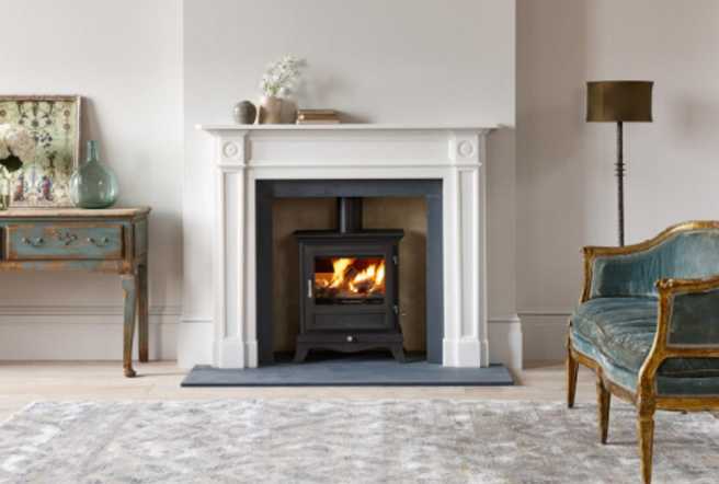 a chesneys stove with white fireplace